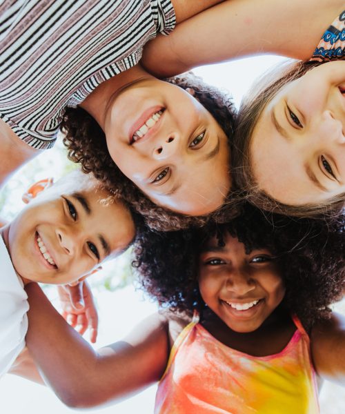 Group of children smiling and looking at the camera diversity Group of children smiling and looking at the camera